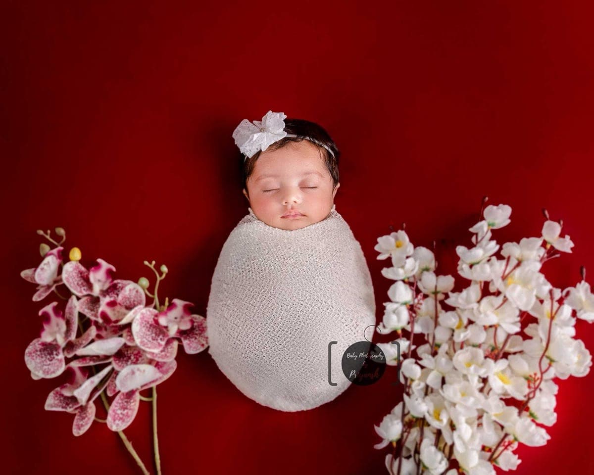 Safe newborn posing with professional handling during a newborn photoshoot in South Delhi by Priyansh Bhardwaj.