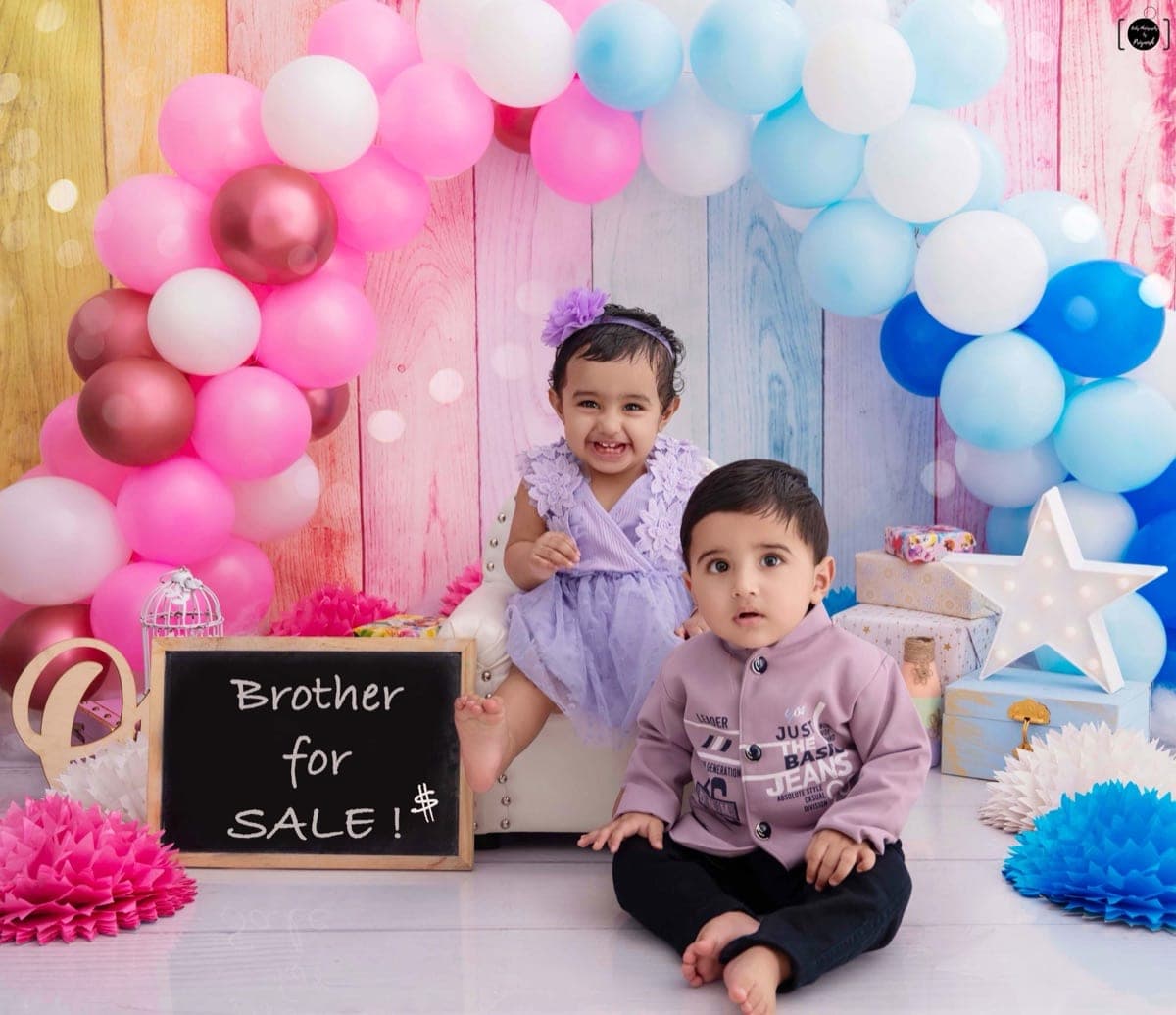 Siblings together at a first birthday setup during a pre-birthday photoshoot in South Delhi