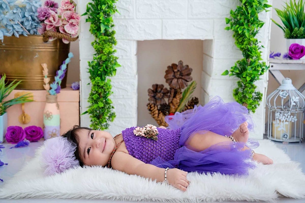 Toddler laughing during a play-based portrait session in South Delhi studio by Priyansh Bhardwaj.